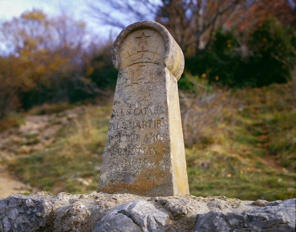 This image has an empty alt attribute; its file name is 126S335Stone-markeratthe-foot-of-Montsegur-commemorating-the-massacre-of-the-Albigenses-1024x805.jpg